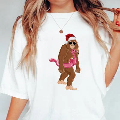 25 Best Bigfoot Christmas Shirts to Make Your Holidays Legendary 18 Funny Bigfoot Flamingo Christmas Shirt Tropical Holiday Sasquatch Tee